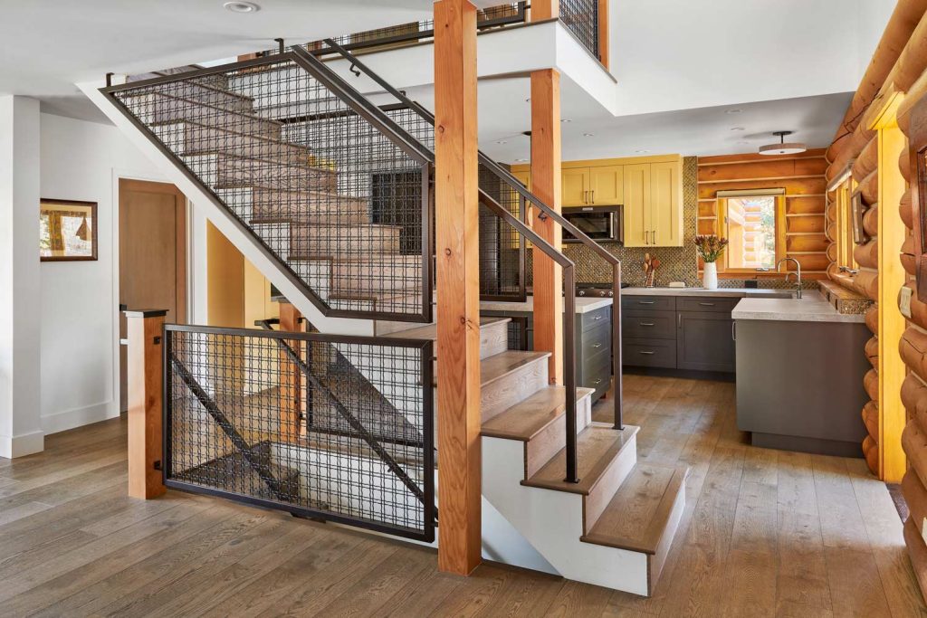 A log cabin kitchen with stairs leading up and downstairs