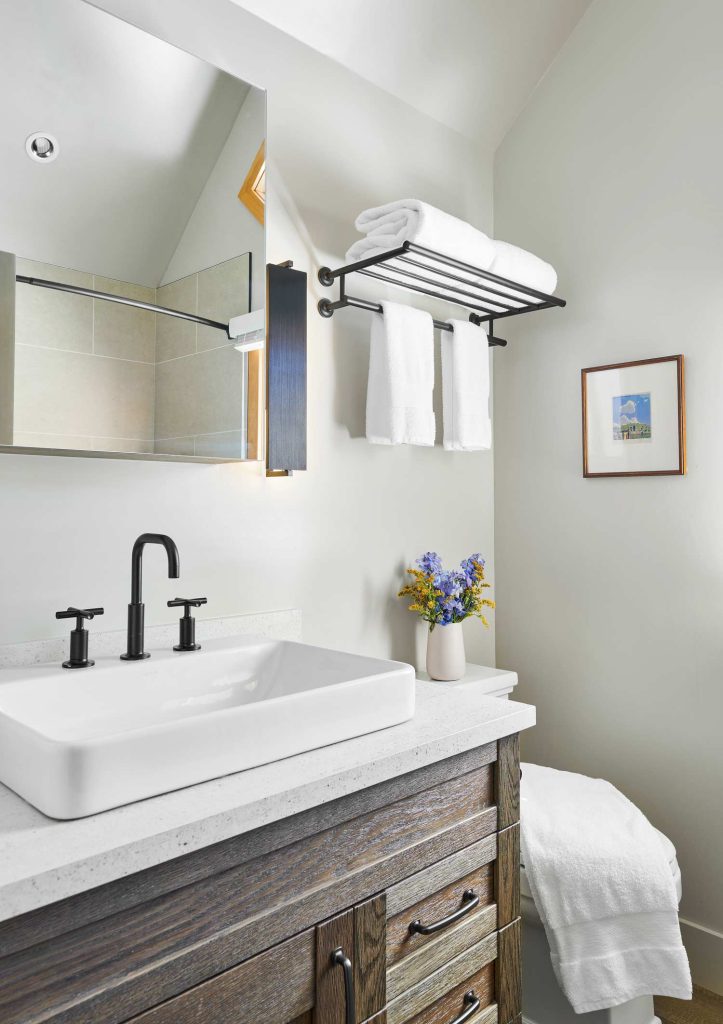 A luxury white bathroom with rustic wood cabinets