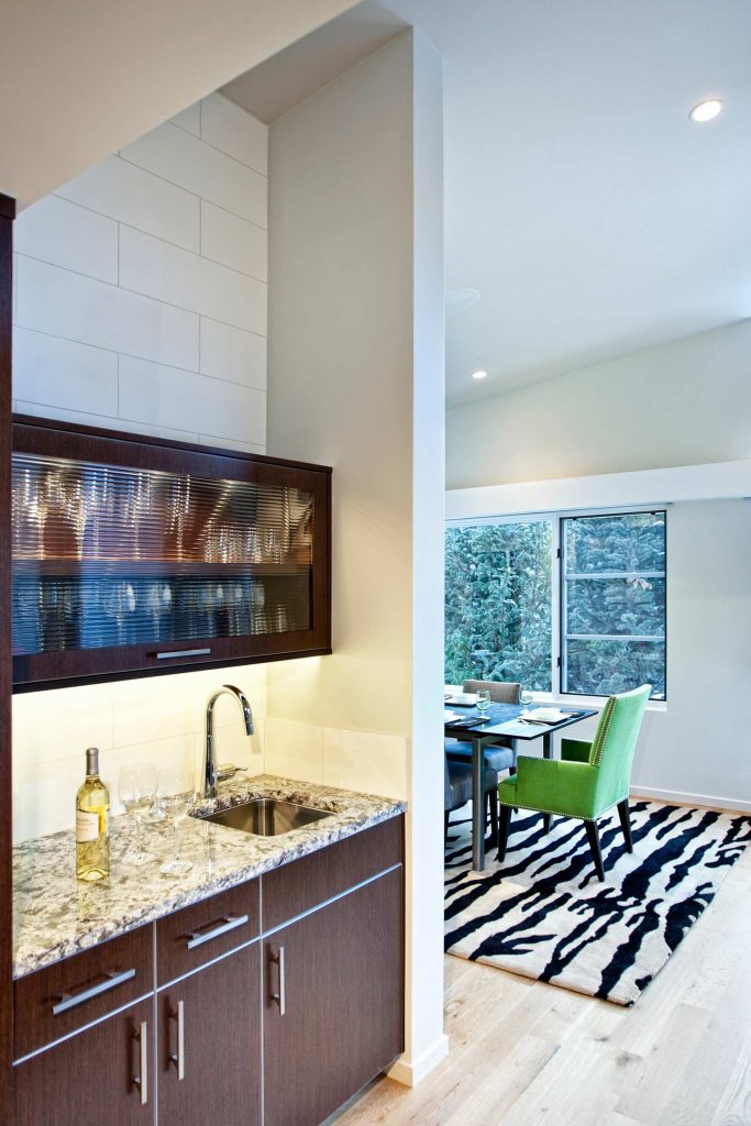 Custom bar cabinetry overlooking a dining room