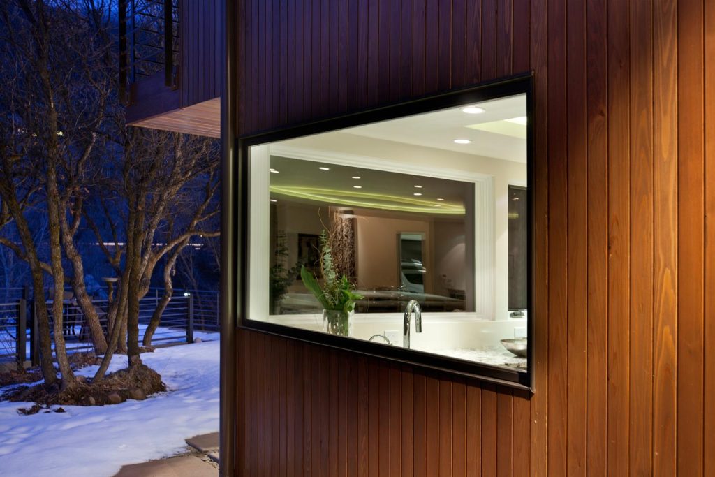 A view of a kitchen with glass windows from the outside