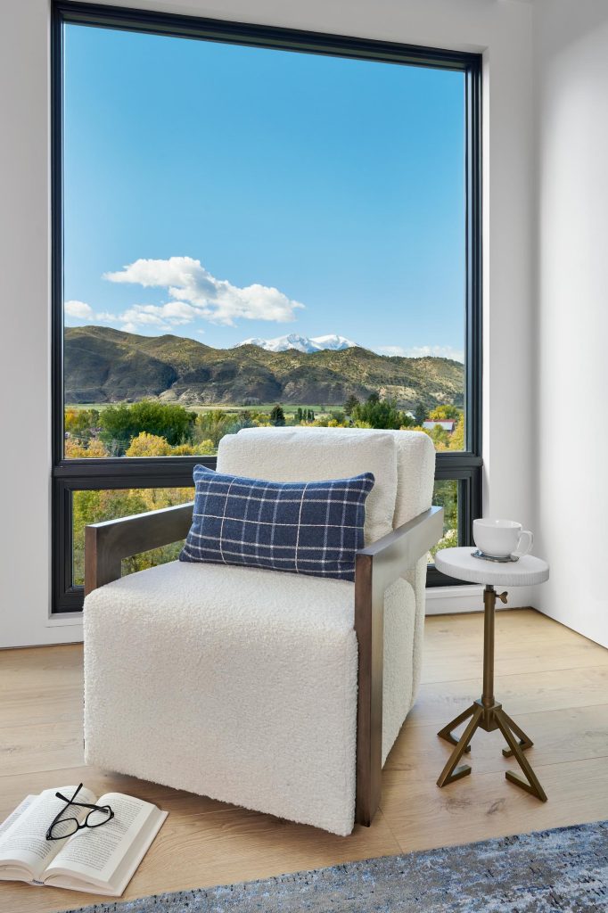 A reading chair posed artfully by a window view