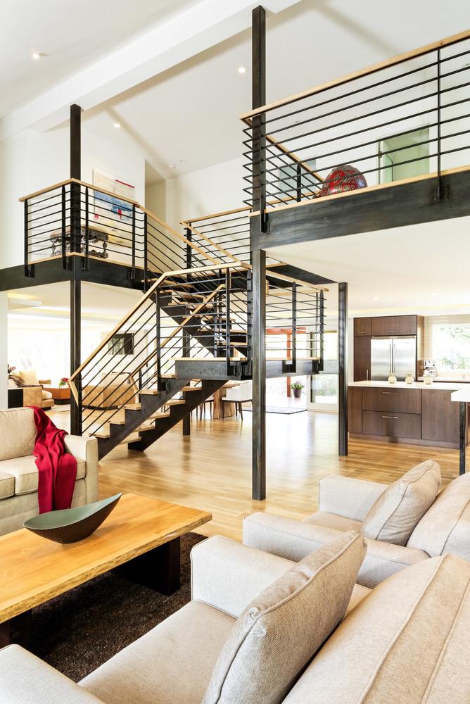 An open floor plan area containing the staircase and two separate living room areas