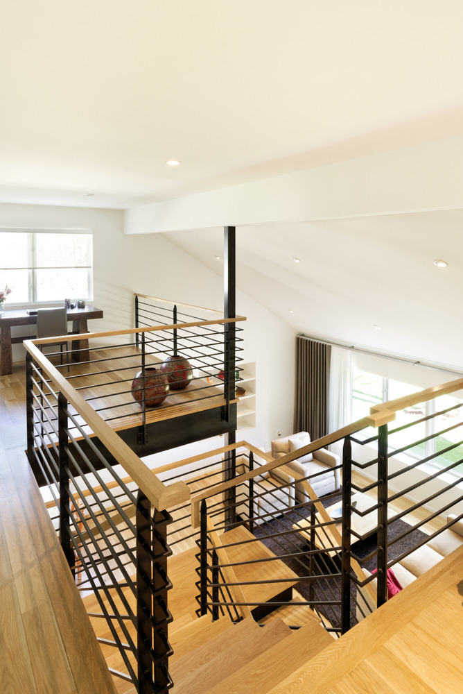 An unenclosed office space by a winding staircase