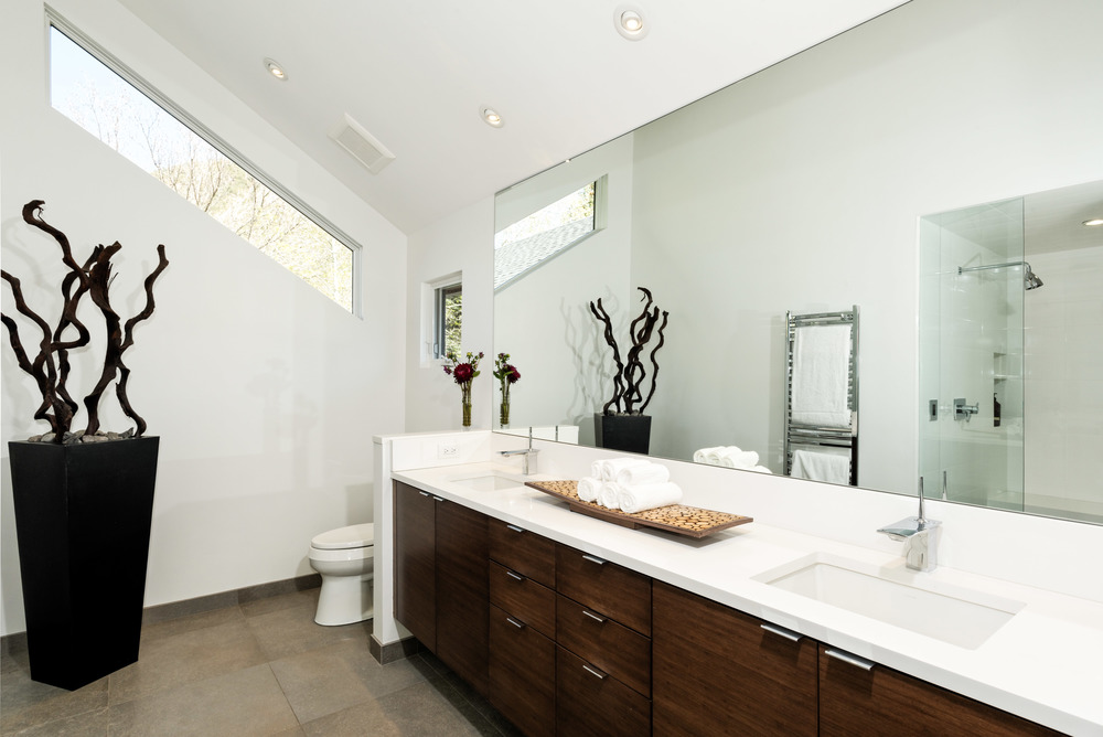 A white luxury bathroom with a glass shower