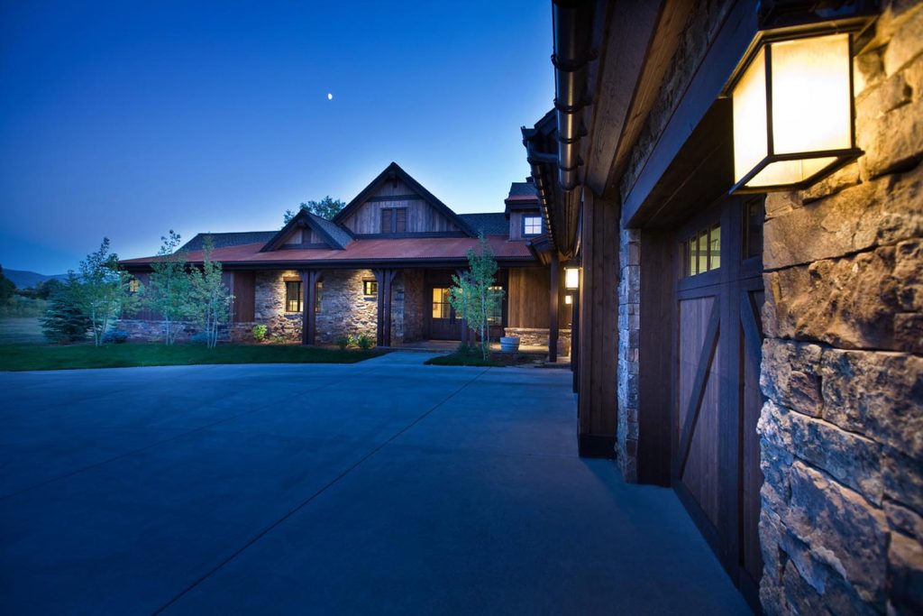 The garage, driveway and street view of a custom luxury home