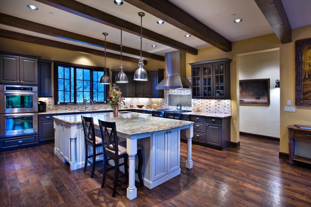 An upscale kitchen with a range top and custom island