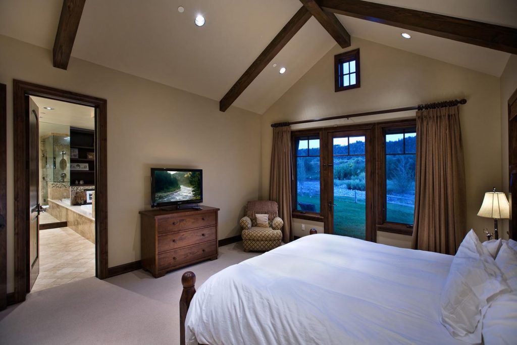 A master bedroom with a vaulted ceiling