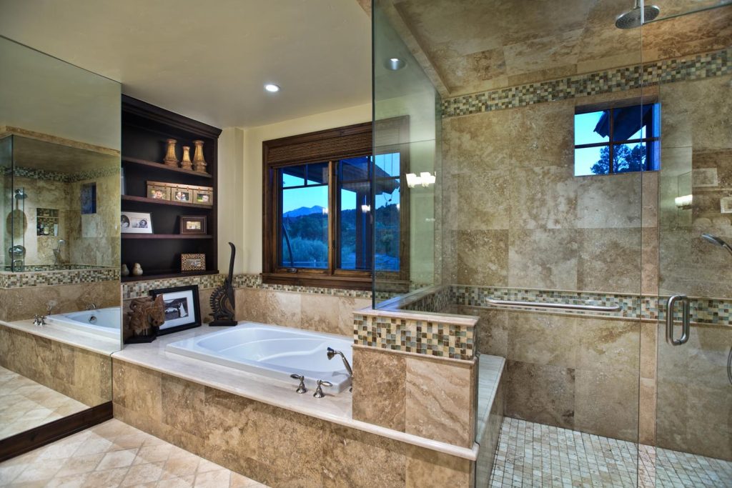 An inset tub and a luxury glass shower