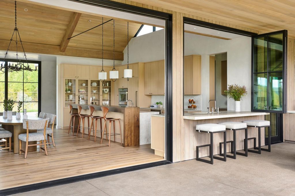 A custom kitchen that opens into a secondary outdoor kitchen