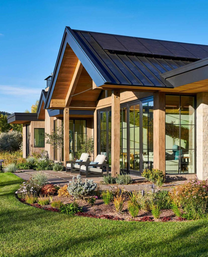 A porch with a glass sunroom behind it