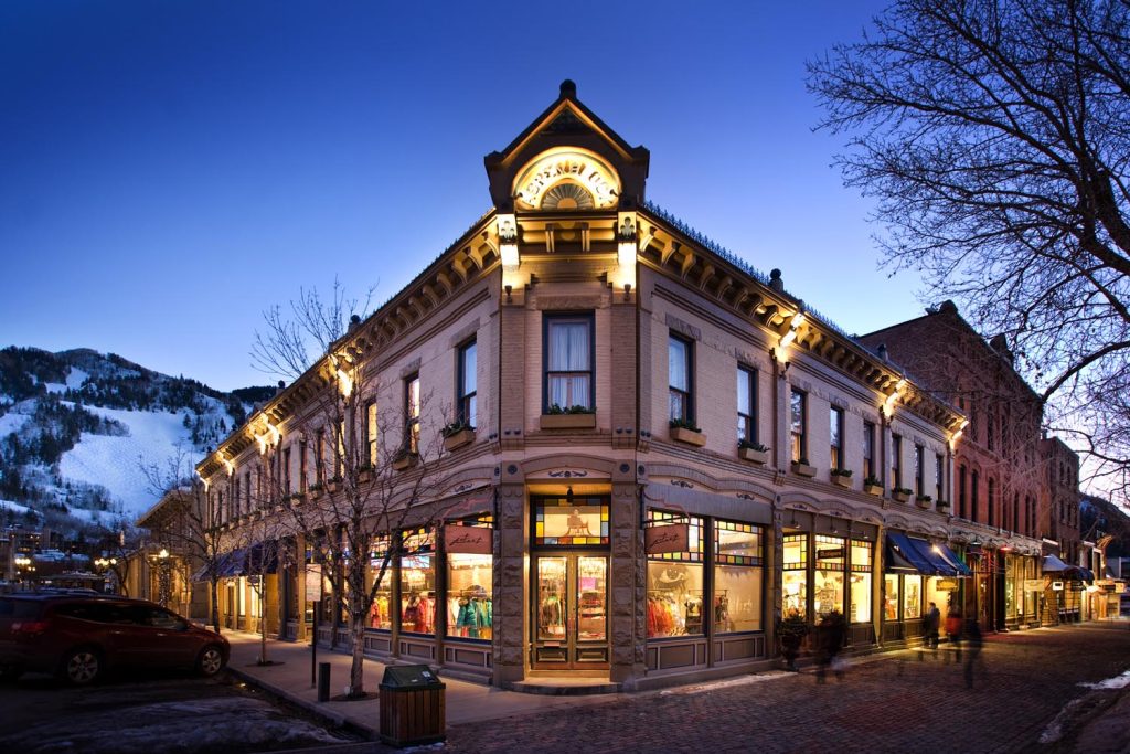 A luxury boutique on a street corner with stained glass windows