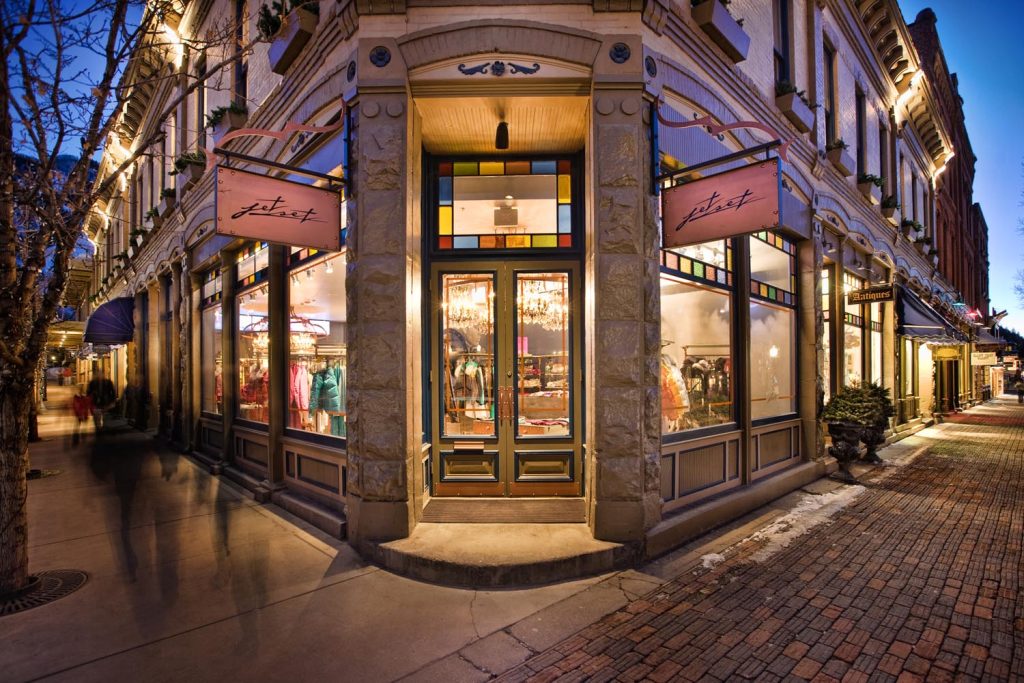 A boutique's front door, aglow at night