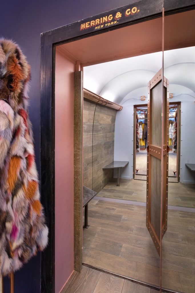 A custom changing room with a ceiling-to-floor mirror