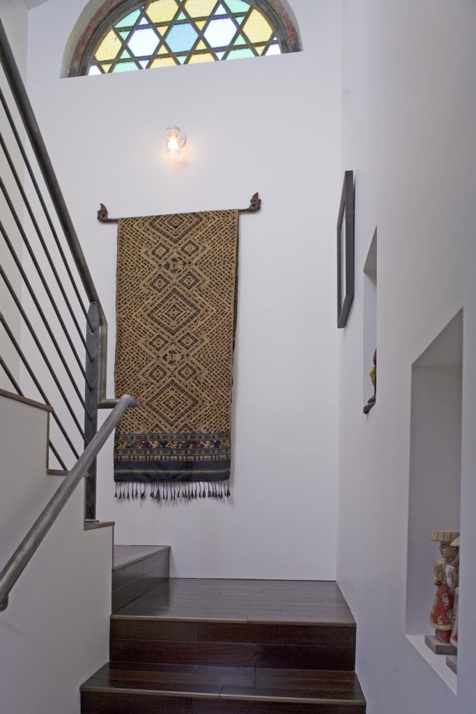 A stairway with a stained-glass window