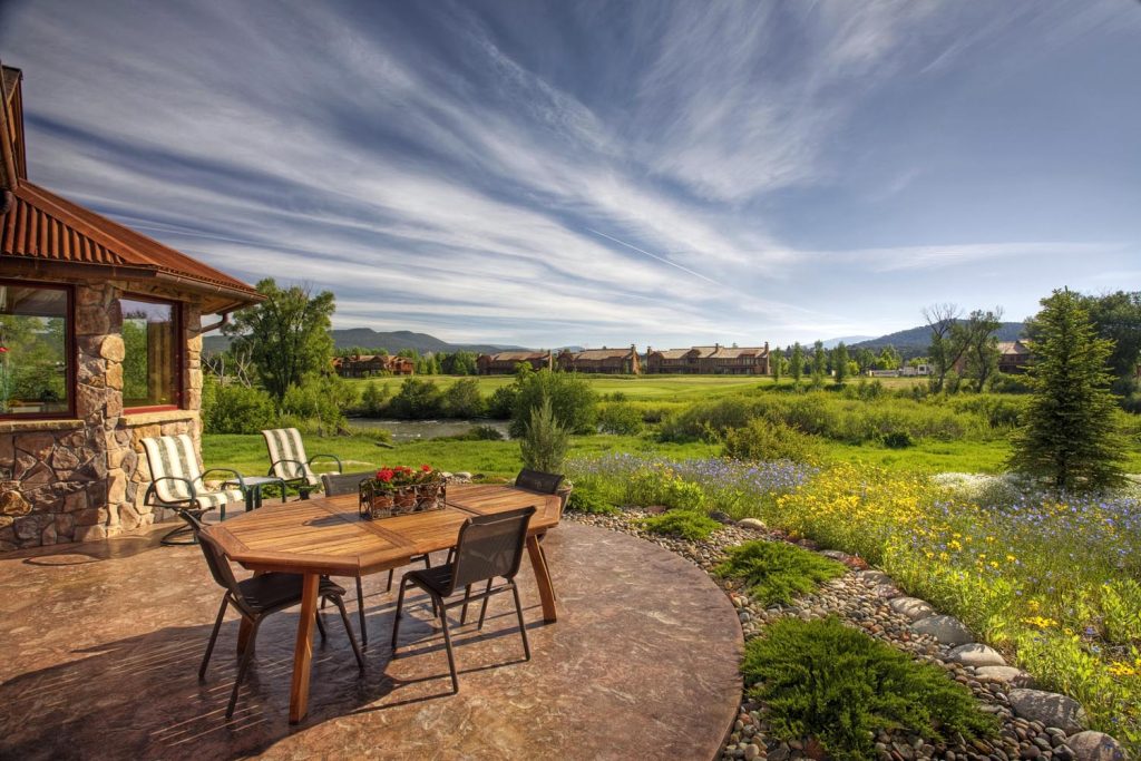 The exterior of a luxury home and its patio