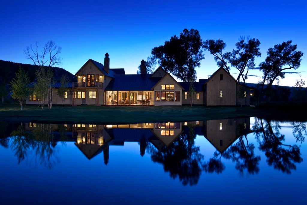 A luxury home at night on the waterfront
