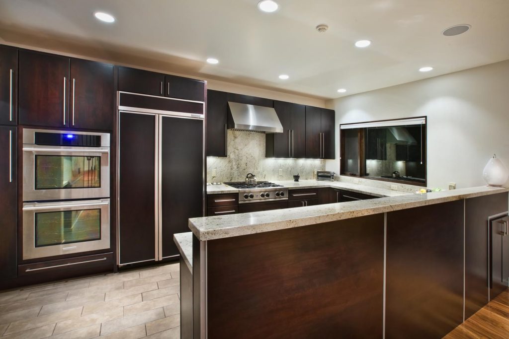 A custom kitchen with dark wood cabinetry