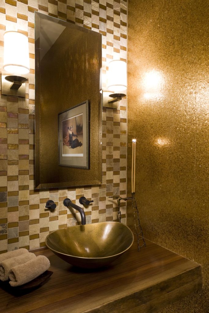 A luxury bathroom done in gold with custom tiling