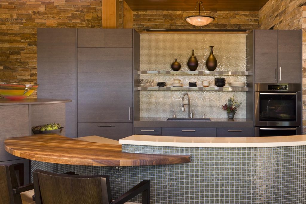 A custom crescent kitchen island and seating area