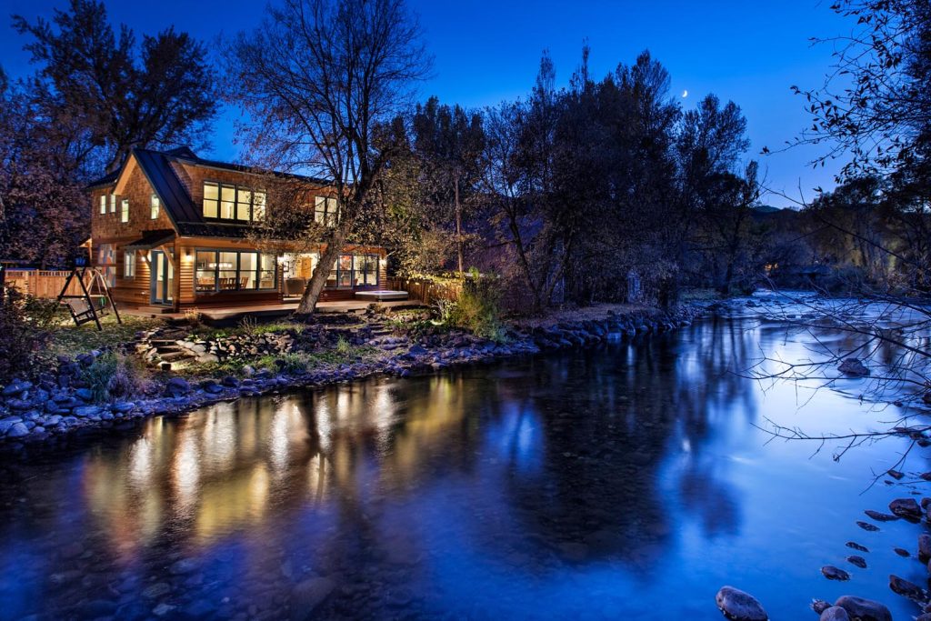 A luxury home on the waterfront at night