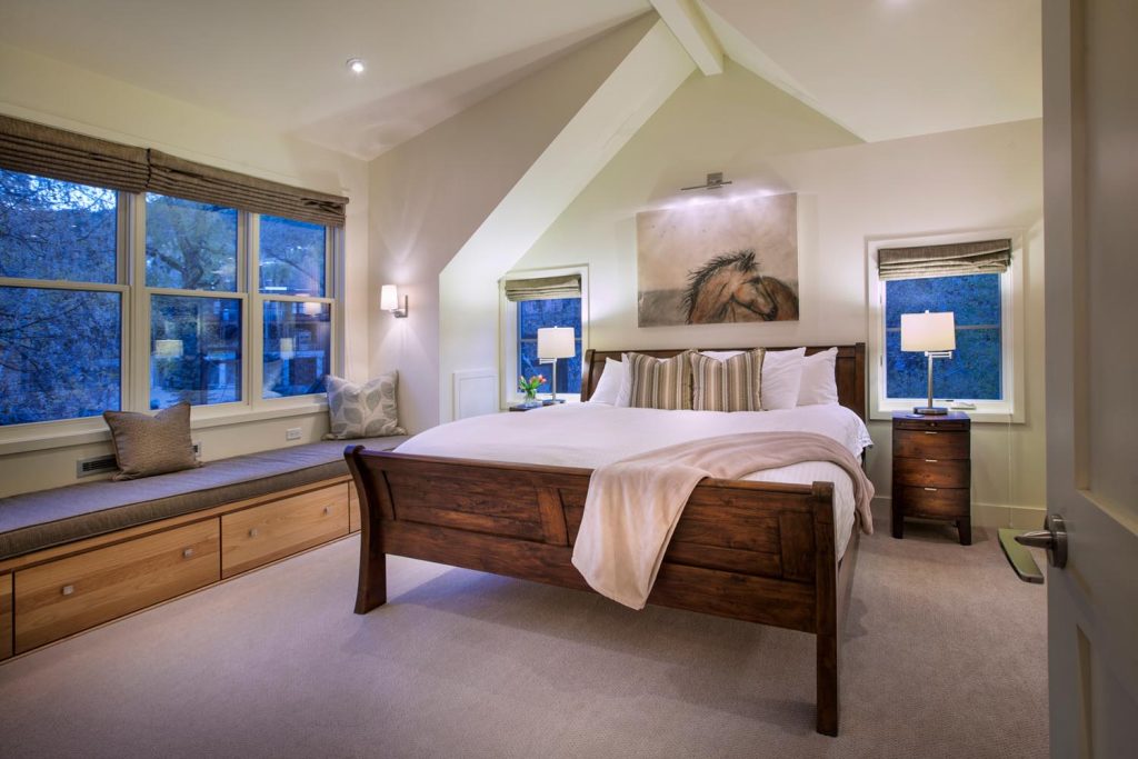 A vaulted ceiling makes this master bedroom feel airy and light