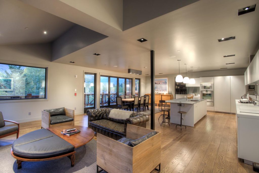 An upscale open floor plan of a kitchen, dining and living room area