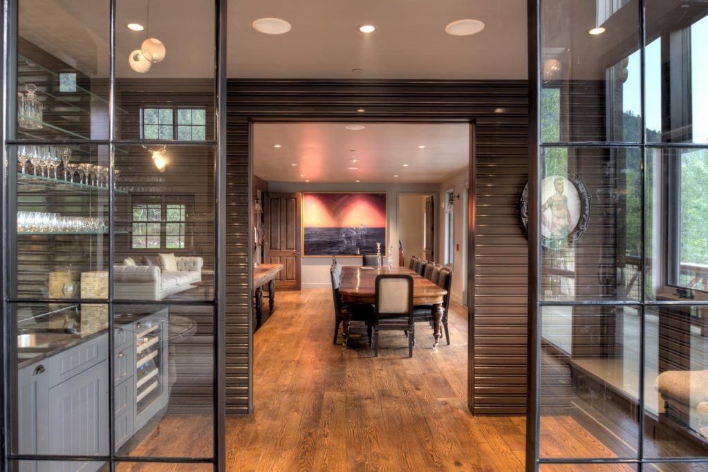 A small personal bar and preparation space lead into the main dining room