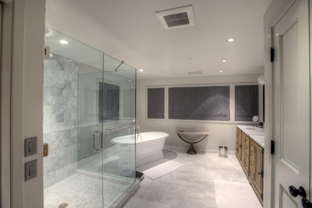 A luxury gray bathroom with a freestanding tub