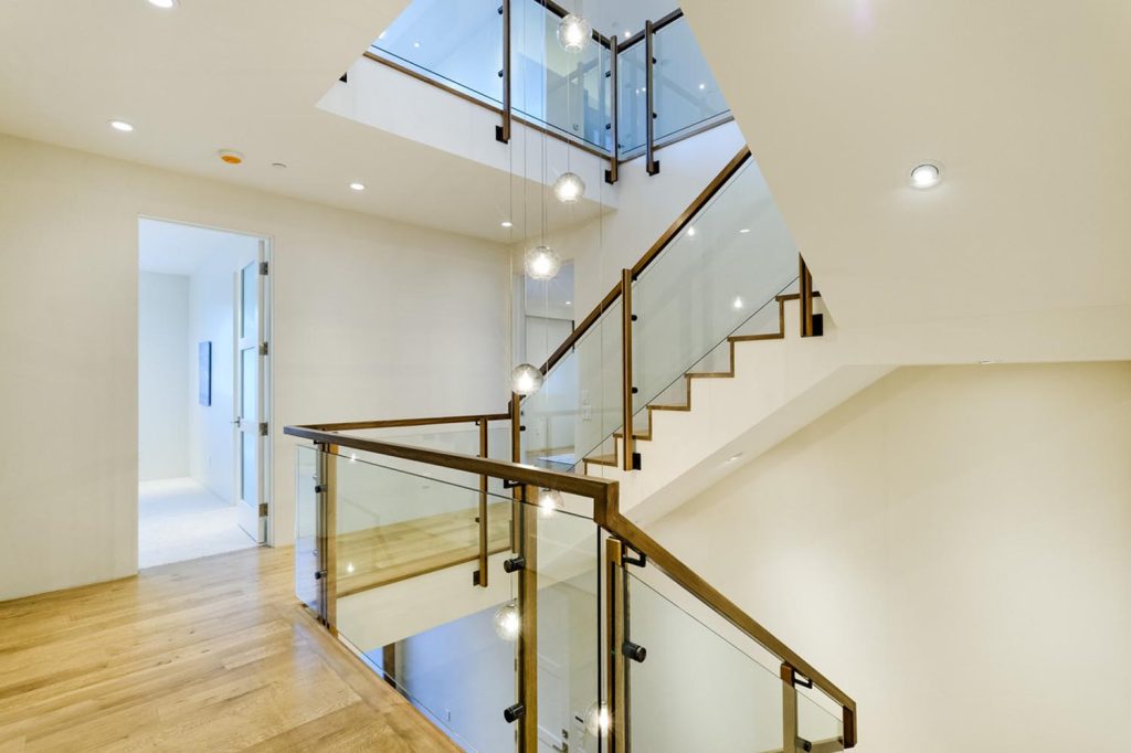 A luxury staircase with glass panels rather than spindles