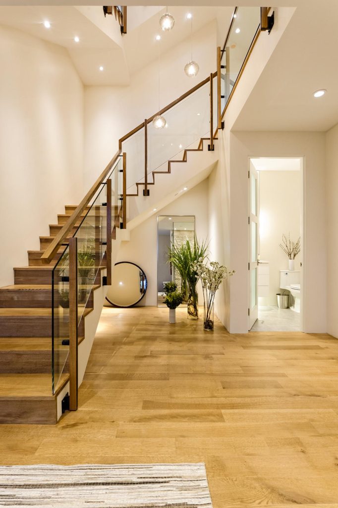 A staircase entryway with a half-bath