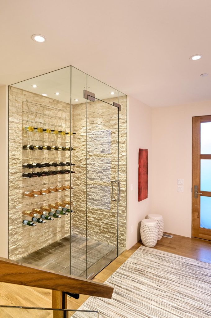 A custom glass room for wine bottle storage