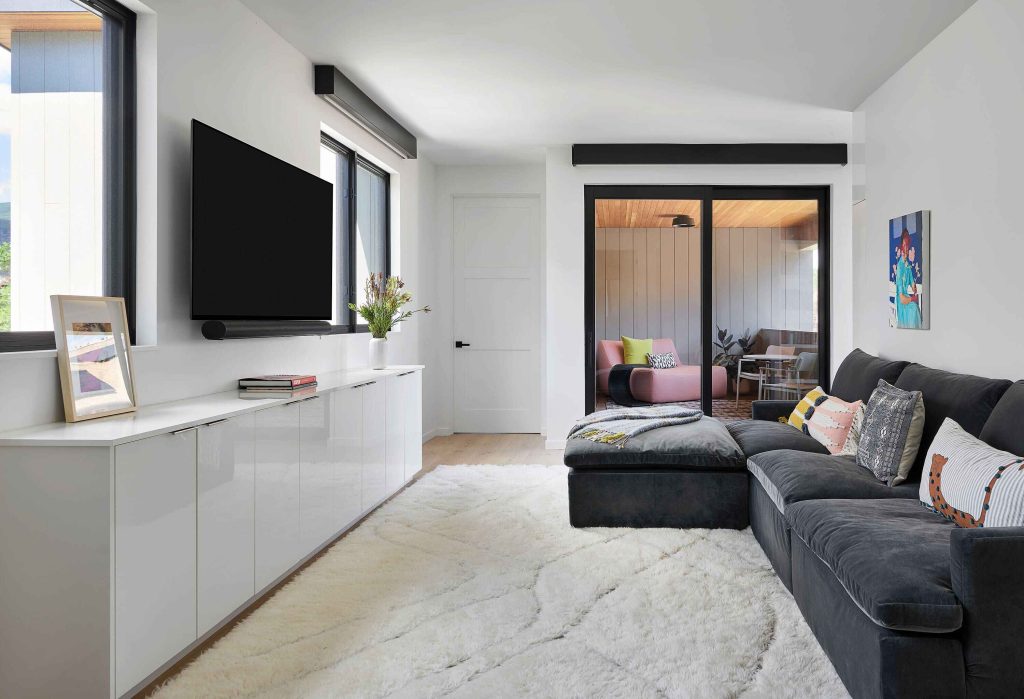 A sleek bonus room looking out to the balcony.